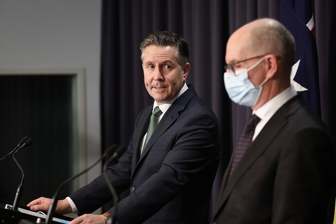 Mark Butler looks at Paul Kelly during a press conference