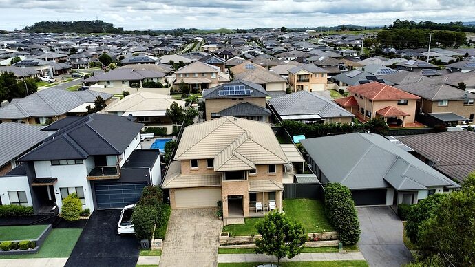A drone shot of a new housing estate, with houses stretching as far as the eye can see